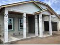 Covered porch area of a new home under construction, showcasing support columns and concrete slab at 5728 Haystack Drive, St Cloud, FL 34771