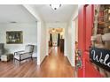 Inviting foyer with hardwood floors, open access to living spaces, and a welcoming red front door at 6642 Parson Brown Dr, Orlando, FL 32819