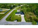 Aerial view of home in a suburban neighborhood, featuring well-manicured lawns and tree coverage at 1430 Tern Ct, Poinciana, FL 34759