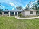 Attractive home with a well-maintained lawn and decorative landscaping around the front entrance at 5080 Maple Dr, Lakeland, FL 33810