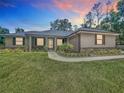 Charming single-story home with well-manicured lawn and lovely landscaping at 5080 Maple Dr, Lakeland, FL 33810