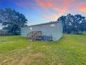 Backyard view of a single-story home showing back entrance and lawn at 5268 Rock Dove Loop, Lakeland, FL 33810