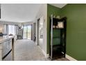 Open floor plan from kitchen to bedroom with sliding glass doors to a balcony and a mirrored closet at 6165 Carrier Dr # 1309, Orlando, FL 32819