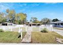 Charming single story home with an inviting walkway, and white picket fence at 1616 Huntington St, Lakeland, FL 33801