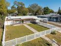 Charming home with a well-manicured lawn, white picket fence, and inviting walkway at 1616 Huntington St, Lakeland, FL 33801
