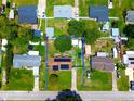 Aerial view of a home surrounded by a fenced yard with mature trees in a quiet residential neighborhood at 1841 Talmadge St, Deland, FL 32724