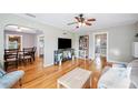 Bright living room showcasing hardwood floors, open layout, and easy access to the dining area and bathroom at 549 Palencia Pl, Lakeland, FL 33803