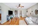 Comfortable living room featuring gleaming hardwood floors, neutral paint, and an inviting cozy atmosphere at 549 Palencia Pl, Lakeland, FL 33803
