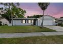 Charming single-story home with a well-manicured lawn and a two-car garage at 446 Eagle Cir, Casselberry, FL 32707