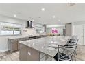 Bright kitchen with a spacious island, modern appliances, and stylish bar stool seating at 446 Eagle Cir, Casselberry, FL 32707