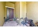 Covered front porch with seating, plants and view of front door at 890 Marisa Ln, Kissimmee, FL 34744