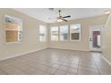 Bright living space with tile floors, ceiling fan, and multiple windows, perfect for entertaining at 12975 Calderdale Ave, Windermere, FL 34786