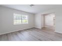 Bright living room with neutral walls, modern flooring, and a large window for ample natural light at 1327 Glenview Ln, Lakeland, FL 33813