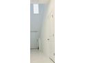 Bright entryway with high ceilings, white walls, and a view of the staircase at 2847 Big Sur Rd, Davenport, FL 33837