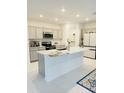 Modern kitchen featuring stainless steel appliances, gray cabinetry, and a large kitchen island at 2847 Big Sur Rd, Davenport, FL 33837