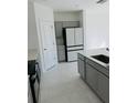 Kitchen showcasing gray cabinetry, stainless steel appliances, and sleek countertops at 2847 Big Sur Rd, Davenport, FL 33837