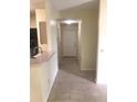 Tiled entryway leading to the front door with a partial view of the kitchen at 709 Secret Harbor Ln # 313, Lake Mary, FL 32746