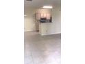 Open living space with tile floors and a view of the kitchen area at 709 Secret Harbor Ln # 313, Lake Mary, FL 32746