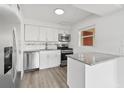 Modern kitchen featuring white cabinets, stainless steel appliances, and granite countertops at 5008 Vanguard St, Orlando, FL 32819