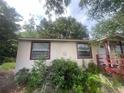A charming home displaying windows and a side porch amidst lush greenery at 7175 Se 123Rd Pl, Belleview, FL 34420