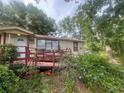 Cozy single-story home with a covered front porch and lush landscaping at 7175 Se 123Rd Pl, Belleview, FL 34420