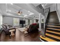 Spacious living room features a staircase, hardwood floors, and a ceiling fan at 530 S Eola Dr, Orlando, FL 32801