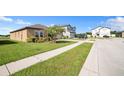 Landscaped front yard and a sidewalk of a one story home on a sunny day in a quiet neighborhood at 4710 Osprey Way, Winter Haven, FL 33881