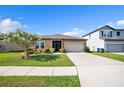Attractive single-story house with a neatly maintained lawn, a two car garage, and an inviting screened porch at 4710 Osprey Way, Winter Haven, FL 33881
