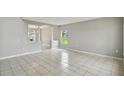 Bright living space features tile flooring, gray walls, natural light, and archways to other rooms at 811 Abbeville Ct, Kissimmee, FL 34759