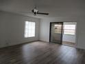 Bright, airy living room with new flooring, ceiling fan and sliding glass doors to the porch at 661 Lake Carolyn Cir, Lakeland, FL 33813