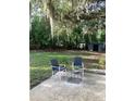 Spacious backyard featuring patio furniture with beautiful landscaping under mature shade trees at 309 Sunnyside Ln, Debary, FL 32713