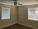 Bedroom with wood-look laminate flooring, light colored walls, a ceiling fan, and natural light at 309 Sunnyside Ln, Debary, FL 32713