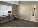 Neutral living room with light walls, a built-in bookcase, and dark wood-look laminate flooring at 309 Sunnyside Ln, Debary, FL 32713