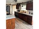 Open kitchen features wood cabinets, a stainless steel sink, and modern appliances at 4119 Chambers St, Lake Wales, FL 33898