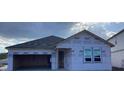 Exterior view of a new construction home with siding, a dark shingled roof and an attached two car garage at 2244 Broadbrook Drive, St Cloud, FL 34771
