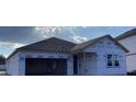 Exterior view of a new construction home with siding, a dark shingled roof and an attached two car garage at 2244 Broadbrook Drive, St Cloud, FL 34771