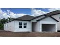 New construction home featuring a garage, double windows, and light gray siding at 2373 Broadbrook Drive, St Cloud, FL 34771