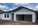 New construction home featuring a garage, double windows, and light gray siding at 2373 Broadbrook Drive, St Cloud, FL 34771