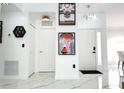 Bright hallway featuring modern decor, marble flooring, and stylish gold light fixtures at 2526 Sage Dr, Kissimmee, FL 34758