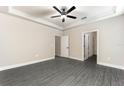 Large main bedroom featuring trey ceilings, crown molding, gray floors and multiple doorways at 7728 Somersworth Dr, Kissimmee, FL 34747