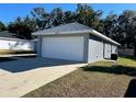 Two-car garage with ample parking space at 9320 Se 163Rd St, Summerfield, FL 34491