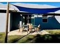 Relaxing patio with shade cover, perfect for outdoor dining at 9320 Se 163Rd St, Summerfield, FL 34491