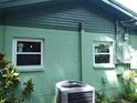 Newly painted side of the house with updated windows and AC unit at 422 22Nd Sw St, Winter Haven, FL 33880