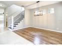 Dining room features wood flooring, light gray walls, black metal chandelier and natural light at 319 Ravenshill Way, Deland, FL 32724