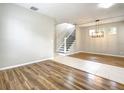 Spacious living room featuring wood floors, natural light, and stairway to the upper level at 319 Ravenshill Way, Deland, FL 32724
