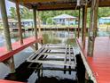 Private dock featuring a boat lift offering convenient access to the water and secure storage for your watercraft at 1628 Paradise Ln, Astor, FL 32102