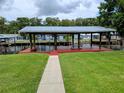 Waterfront property boasts a large covered dock, perfect for outdoor entertaining and enjoying the serene lake views at 1628 Paradise Ln, Astor, FL 32102