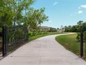 Long driveway leading to the house with wrought iron gates at 32200 Ponderosa Ave, Deland, FL 32720