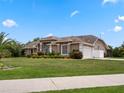 House exterior showcasing a side view with a two-car garage at 32200 Ponderosa Ave, Deland, FL 32720