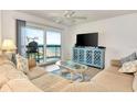 Inviting living room with a large sliding door, balcony, and views of the ocean at 1513 Ocean Shore Blvd # 7B, Ormond Beach, FL 32176